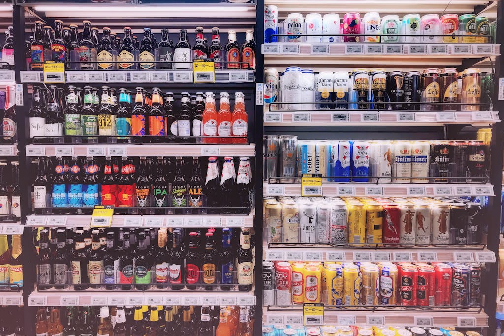 Assorted Bottles and Cans in Commercial Coolers