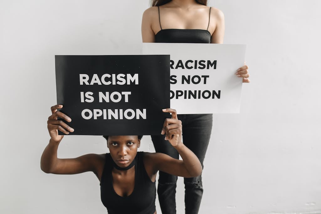 Two Activists Holding Anti-Racist Slogans