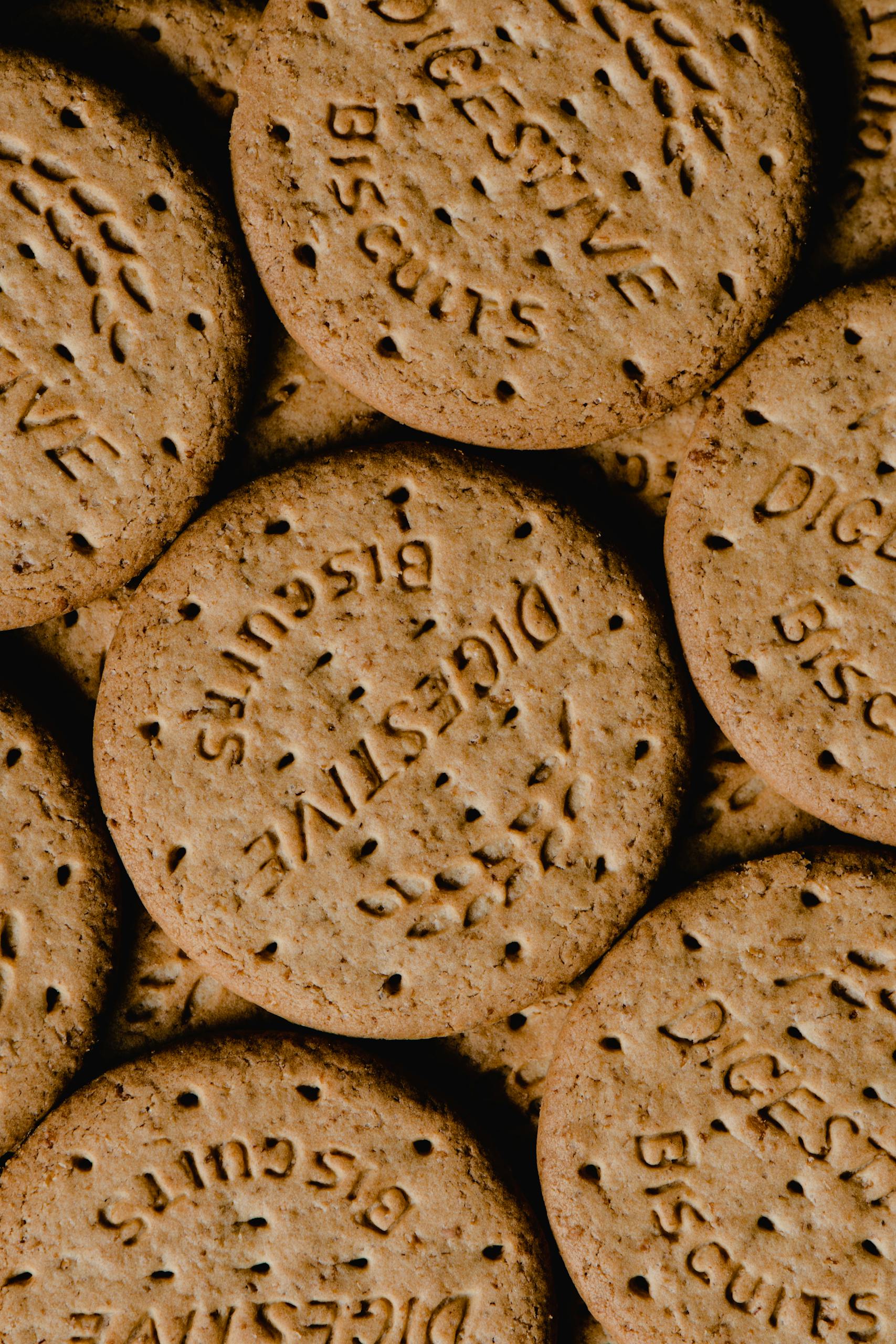 A vertical shot of round digestive biscuits stacked together, showcasing texture and detail.